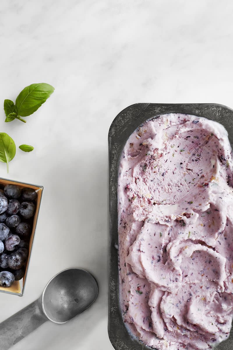 blueberry basil frozen yogurt in a loaf pan with an ice cream scooper