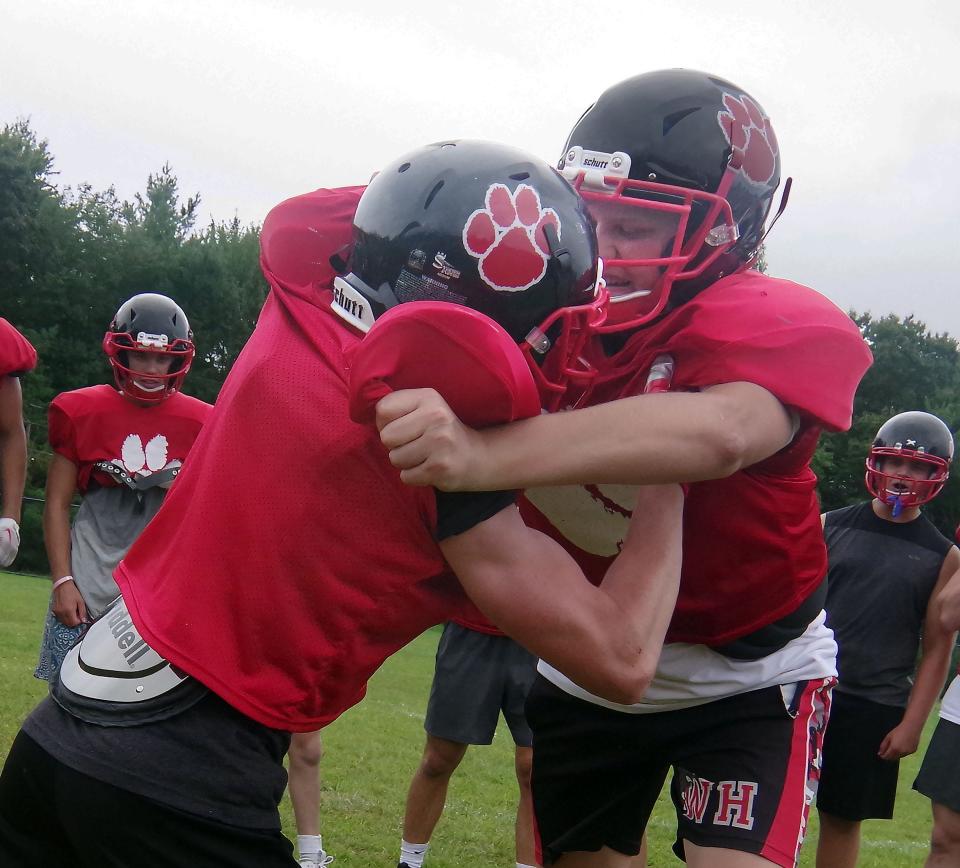 Patrick Ryan and Jack Martin go at each other in a blocking drill during Whitman-Hanson football practice Tuesday, Aug. 29, 2023.