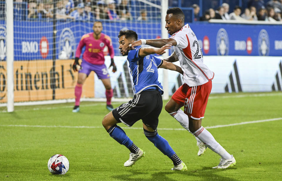 CF Montreal's Mathieu Choiniere, left, is pressured by New England Revolution's Mark-Anthony Kaye during the first half of an MLS soccer match Saturday, Aug. 26, 2023, in Montreal. (Graham Hughes/The Canadian Press via AP)