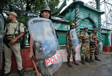 Indian security force personnel stand guard outside a mosque during restrictions following the scrapping of the special constitutional status for Kashmir by the Indian government, in Jammu