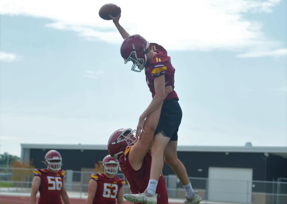 Rocky Mountain football player Ethan Thomason lifts up teammate Owen Wentz at the Coloradoan's high school football media day at the new Poudre School District Stadium on Aug. 2.