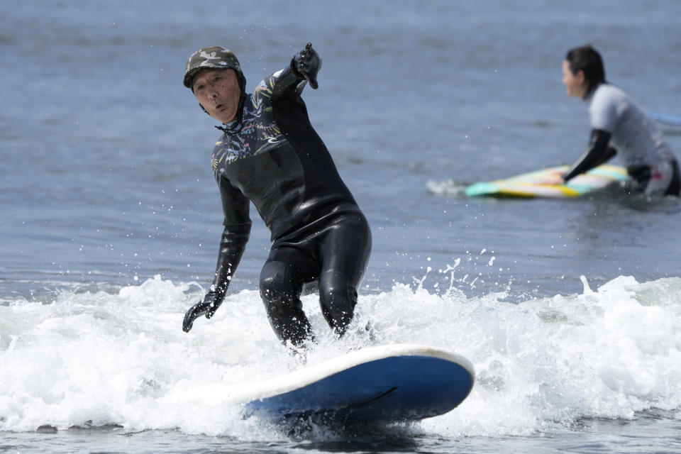 Seiichi Sano, an 89-year-old Japanese man, rides a wave at Katase Nishihama Beach, Thursday, March 30, 2023, in Fujisawa, south of Tokyo. Sano, who turns 90 later this year, has been recognized by the Guinness World Records as the oldest male to surf. (AP Photo/Eugene Hoshiko)