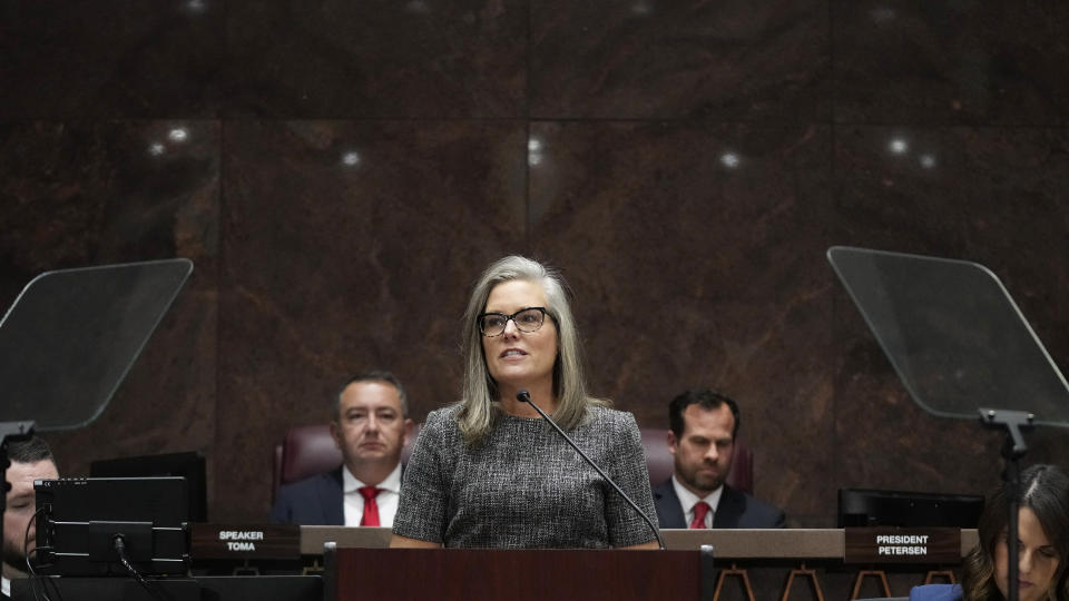 Arizona Democratic Gov. Katie Hobbs, middle, speaks as she gives the state of the state address, flanked by Arizona House Speaker Ben Toma, R-Glendale, left, and Arizona Senate President Warren Petersen, R-Gilbert, right, at the Arizona Capitol in Phoenix, Monday, Jan. 9, 2023. (AP Photo/Ross D. Franklin)