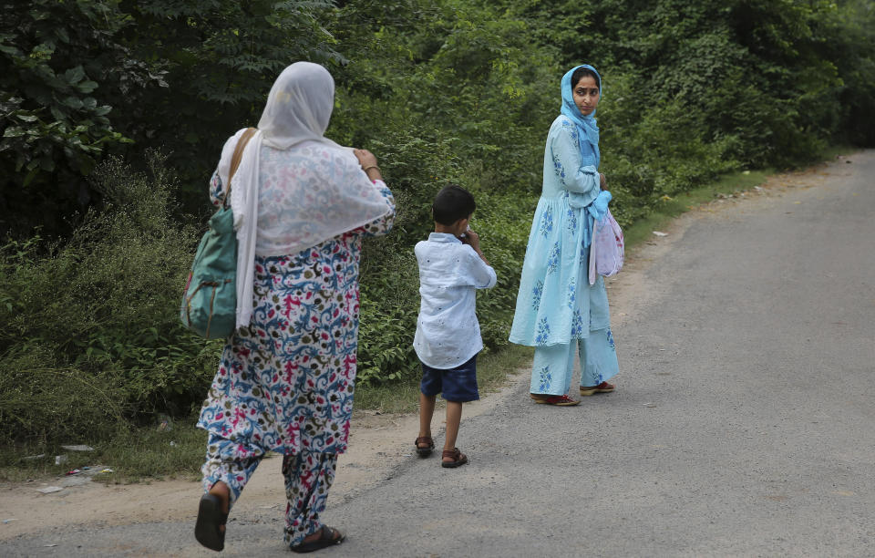 Maryam Rasool, wife of a Kashmiri prisoner Aamir Parviaz Rather who is lodged in Agra central jail, walks with her mother-in-law and son after meeting her husband in Agra, India, Friday, Sept. 20, 2019. Rather was picked up by the armed forces on the morning of Aug. 6 and held in various jails in Kashmir before being moved to Agra. The family was seeing him for the first time in 48 days. “We hugged each other and cried. His face was swollen because of the heat. If they keep him for long, he won’t survive,” Maryam said, tugging her 5-year-old son closely to her. (AP Photo/Altaf Qadri)