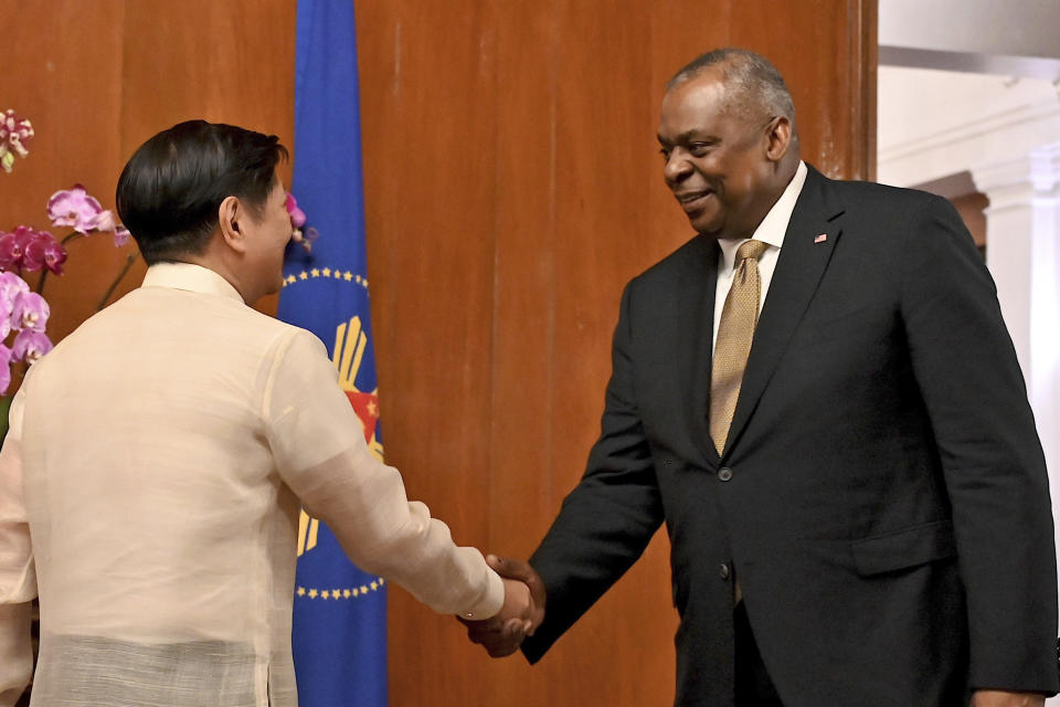 FILE - U.S. Secretary of Defense Lloyd James Austin III, right, shake hands with Philippine President Ferdinand Marcos Jr. during a courtesy call at the Malacanang Palace in Manila, Philippines on Feb. 2, 2023. (Jam Sta Rosa/Pool Photo via AP, File)