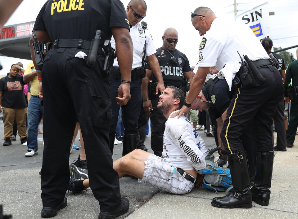 <p>Police take an individual into custody who was protesting against homosexuality outside the Pulse gay nightclub as a memorial service was being held for the one-year anniversary of a mass shooting at the club on June 12, 2017 in Orlando, Florida. (Joe Raedle/Getty Images) </p>