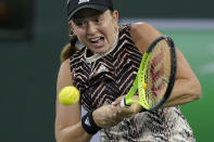 Jelena Ostapenko, of Latvia, returns a shot to Shelby Rogers at the BNP Paribas Open tennis tournament Wednesday, Oct. 13, 2021, in Indian Wells, Calif. (AP Photo/Mark J. Terrill)