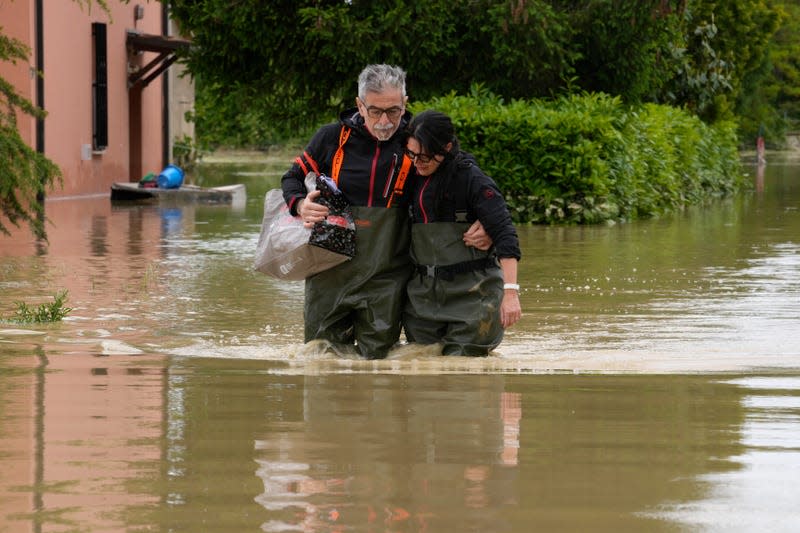 Photo of two people wading in thigh deep water