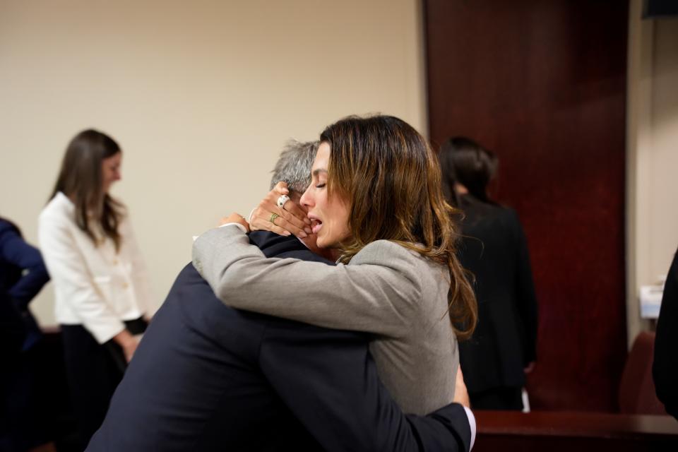 Alec Baldwin and wife Hilaria embrace in a New Mexico courtroom Friday after hearing his involuntary manslaughter case has been dismissed