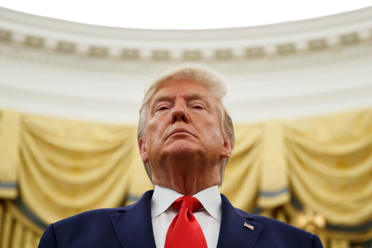 President Donald Trump stands during a Presidential Medal of Freedom ceremony for auto racing great Roger Penske in the Oval Office of the White House, Thursday, Oct. 24, 2019, in Washington. (AP Photo/Alex Brandon)