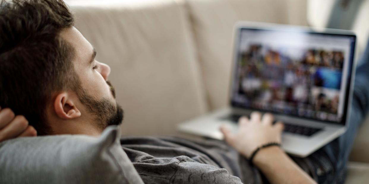 man using laptop watching shows