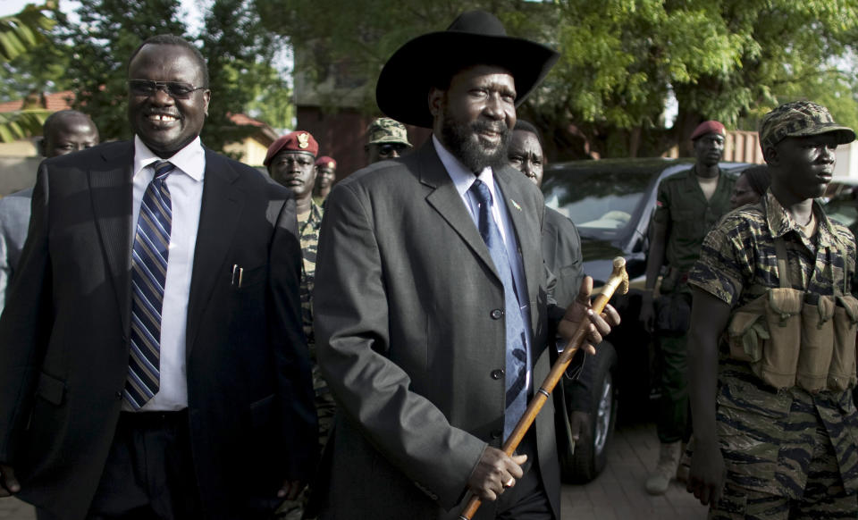 FILE - In this Monday, April 26, 2010 file photo, then Vice President Riek Machar, left, and President of South Sudan Salva Kiir, centre, arrive for a press conference in Juba, South Sudan. A spokesman for South Sudan's president said Wednesday, Jan. 29, 2014 that seven of the 11 leaders accused of plotting a failed military coup in December, whom the commander of rebel forces former Vice-President Riek Machar has repeatedly demanded be freed, have been flown to Kenya where they will still be held in custody. (AP Photo/Pete Muller, File)