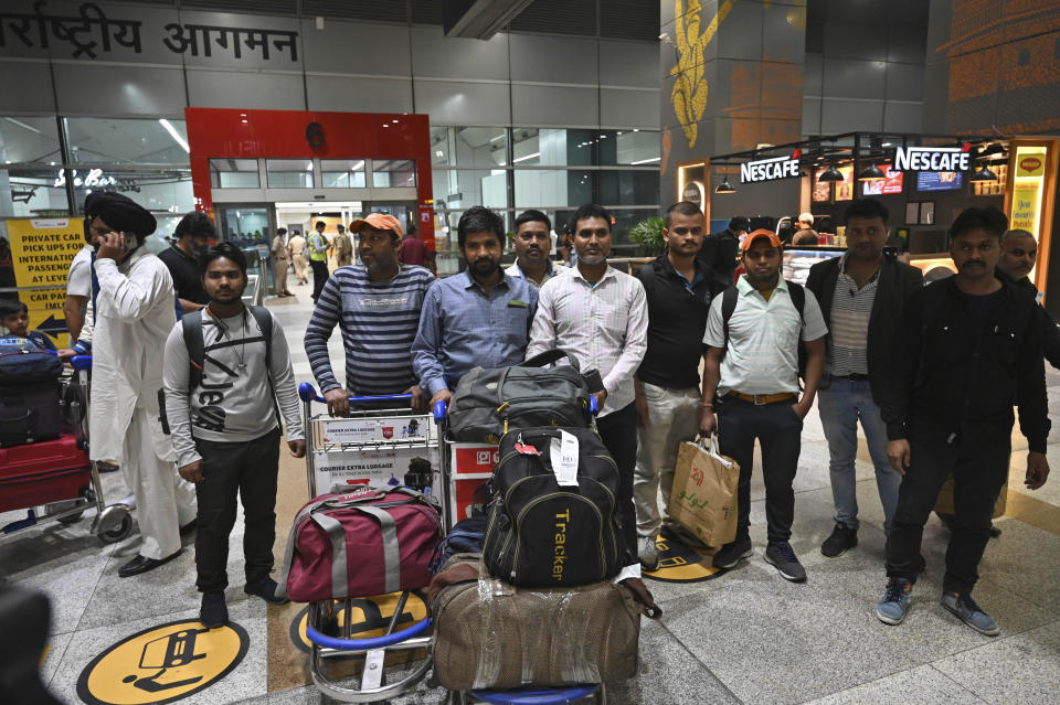 Indians evacuated from Sudan arrive on a flight at the Indira Gandhi International Airport in New Delhi, India, Wednesday, April 26, 2023. (AP Photo)