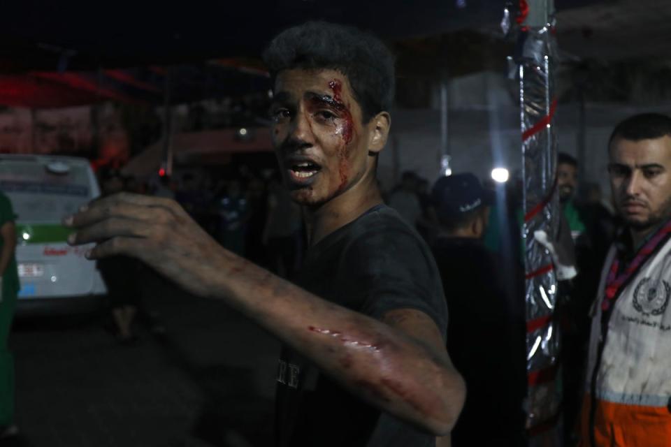 An injured Palestinian man arrives at the al Shifa hospital following Israeli airstrikes on Gaza City (AP)