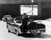 <p>President John F. Kennedy slumps down in the back seat of the presidential limousine as it speeds along Elm Street toward the Stemmons Freeway overpass, after he was fatally shot in Dallas on Nov. 22, 1963. Jacqueline Kennedy leans over the president as Secret Service agent Clinton Hill rides on the back of the car. (Photo: Jim Altgens/AP) </p>