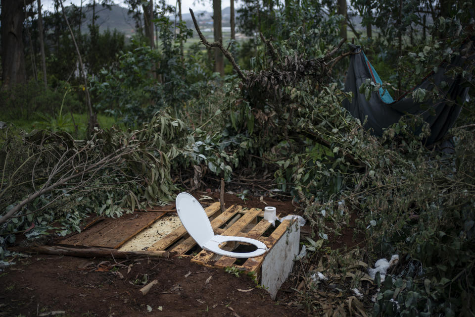 A makeshift toilet is pictured with a toilet seat on a pallet covering a hole in the ground outside Las Raices camp in San Cristobal de la Laguna, in the Canary Island of Tenerife, Spain, Sunday, March 21, 2021. While Spain has been critical of its European neighbours' lack of solidarity when it comes to sharing the responsibility of migration, the country is similarly being criticized by migrants, authorities and human rights organizations on the Canary Islands where some 23,000 people arrived by sea last year and where many thousands remain on the island forcefully. (AP Photo/Joan Mateu)