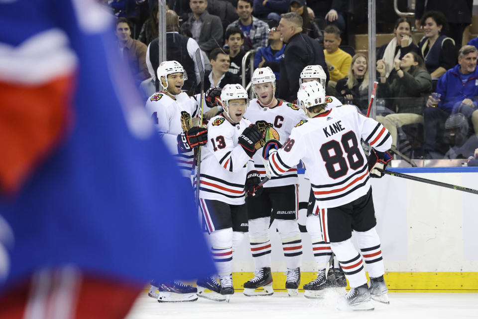 Chicago Blackhawks center Max Domi (13) celebrates with right wing Patrick Kane (88) and additional teammates after scoring a goal against the New York Rangers during the second period of an NHL hockey game, Saturday, Dec. 3, 2022, in New York. (AP Photo/Jessie Alcheh)