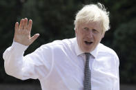 Britain's Prime Minister Boris Johnson waves as he walks to his car following a visit to Hereford County Hospital, in Hereford, England, Tuesday, Aug. 11, 2020. Hereford County Hospital is expanding with a three storey modular building providing 72 new beds over three wards under construction. The new facility will open early 2021. (Matthew Horwood/Pool Photo via AP)