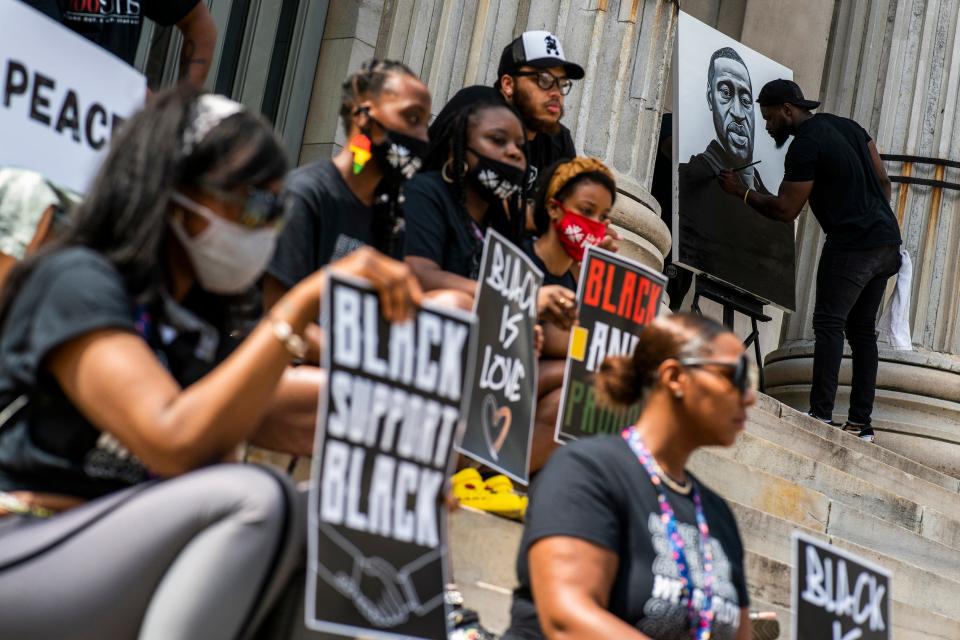 People attend a rally with Terrence Floyd, brother of George Floyd, on Sunday, May 23, 2021, in Brooklyn borough of New York. George Floyd, whose May 25, 2020 death in Minneapolis was captured on video, plead for air as he was pinned under the knee of former officer Derek Chauvin.