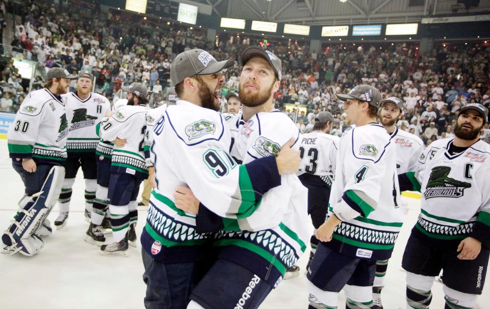 Everblades players David Rutherford, (91) and Bobby Raymond, right, celebrate winning 3-2 in overtime clinching their first ECHL Kelly Cup over Las Vegas at Germain Arena on Wednesday, May 23, 2012.