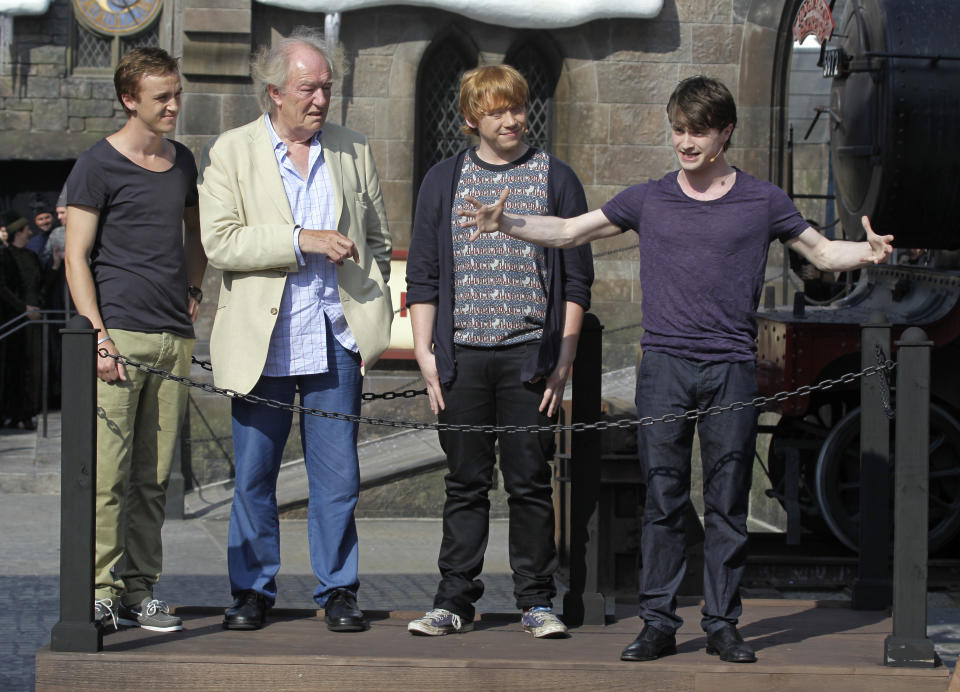 FILE - Members of the cast of the Harry Potter films, from left, Tom Felton, Michael Gambon, Rupert Grint, and Daniel Radcliffe during grand opening ceremonies of the Wizarding World of Harry Potter at Universal Orlando theme park in Orlando, Florida, Friday, June 18, 2010. Actor Michael Gambon, who played Dumbledore in the later Harry Potter films, has died at age 82, his publicist says. (AP Photo/John Raoux, File)