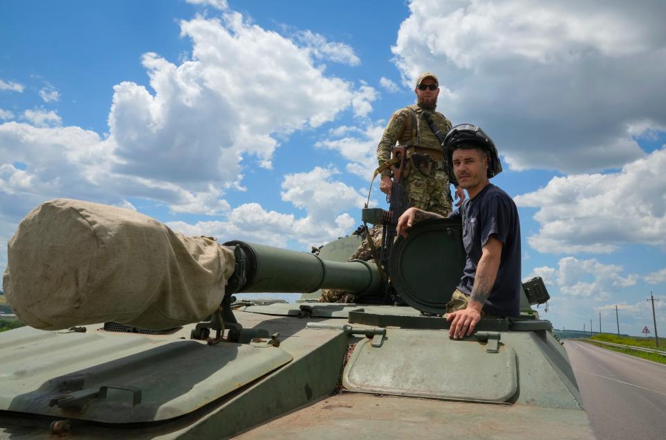 Ukrainian soldiers ride a self-propelled artillery vehicle Gvozdika in the Donetsk region, Ukraine, Friday, June 17, 2022.