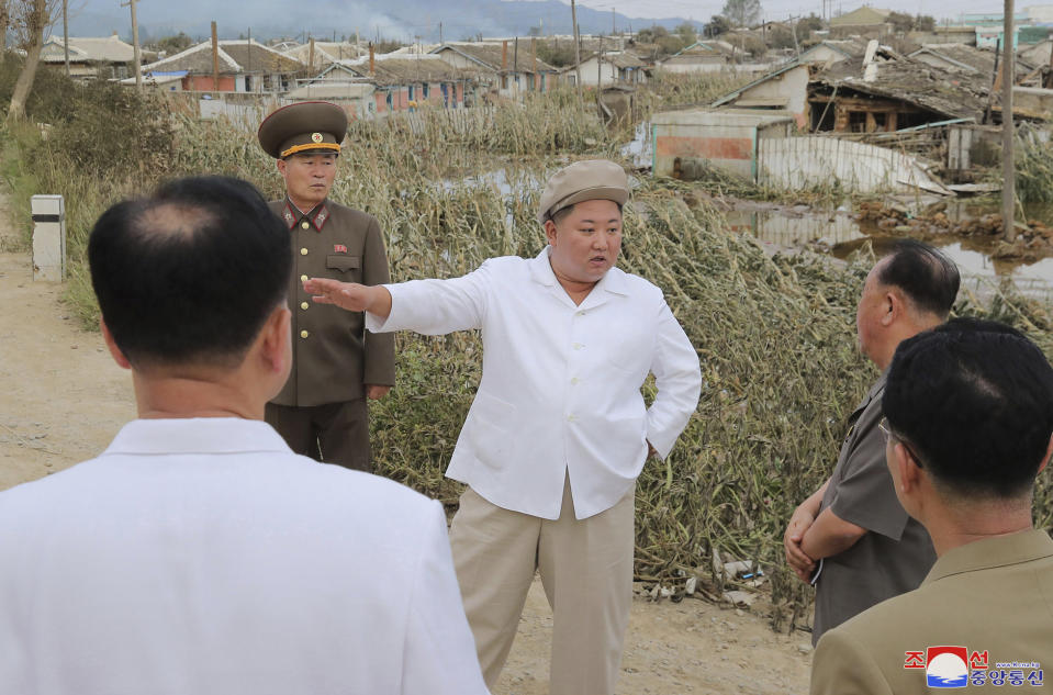 In this Saturday, Sept. 5, 2020, photo provided by the North Korean government, North Korea leader Kim Jong Un talks to officials as he visits a damaged area in the South Hamgyong province, North Korea, following a typhoon known as Maysak. Independent journalists were not given access to cover the event depicted in this image distributed by the North Korean government. The content of this image is as provided and cannot be independently verified. Korean language watermark on image as provided by source reads: "KCNA" which is the abbreviation for Korean Central News Agency. (Korean Central News Agency/Korea News Service via AP)