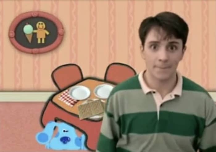Steve from Blue's Clues stands in a room with the animated character Blue and a thinking chair