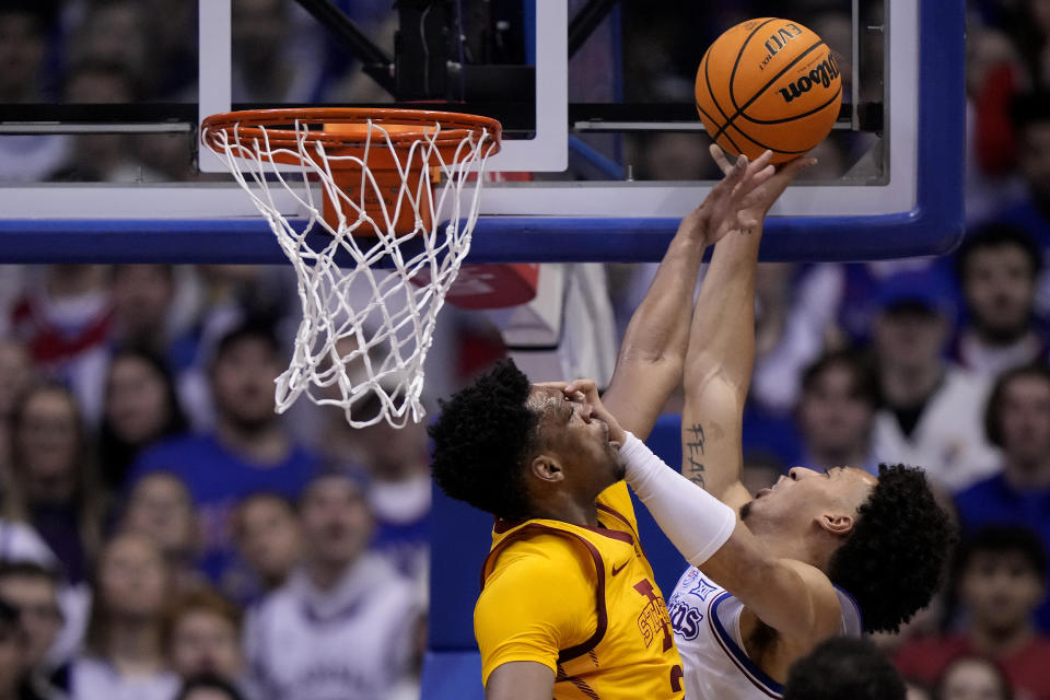 Kansas forward Jalen Wilson, right, shoots over Iowa State center Osun Osunniyi during the second half of an NCAA college basketball game Saturday, Jan. 14, 2023, in Lawrence, Kan. Kansas won 62-60 (AP Photo/Charlie Riedel)