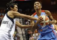 Connecticut Sun's Iziane Castro Marques, left, fouls Atlanta Dream's Angel McCoughtry during the first half of a WNBA basketball game in Uncasville, Conn., Wednesday, Aug. 14, 2013. (AP Photo/Jessica Hill)