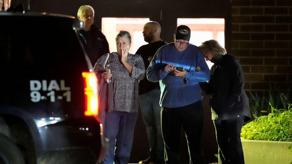 PHOTO: People depart a reunification center early Oct. 26, 2023, at Auburn Middle School, in Auburn, Maine, after shootings in Lewiston. (Steven Senne/AP)