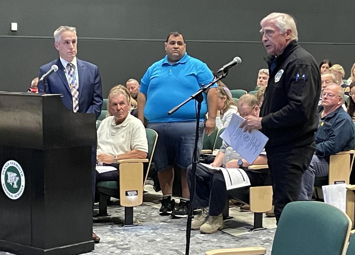 West Yarmouth resident Brian Braginton-Smith, right, strongly supported the Dennis-Yarmouth school budget at the Yarmouth town meeting Tuesday, saying it was needed “to secure our future.” Superintendent of Schools Marc Smith, left, and School Committee treasurer Tomas Tolentino, center, listen.