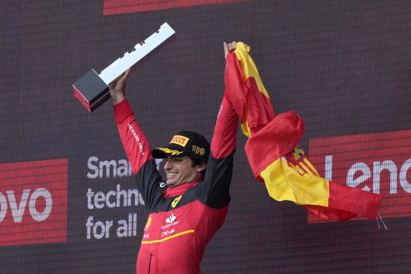 Ferrari driver Carlos Sainz of Spain celebrates on the podium winning the British Formula One Grand Prix at the Silverstone circuit, in Silverstone, England, Sunday, July 3, 2022. (AP Photo/Frank Augstein)