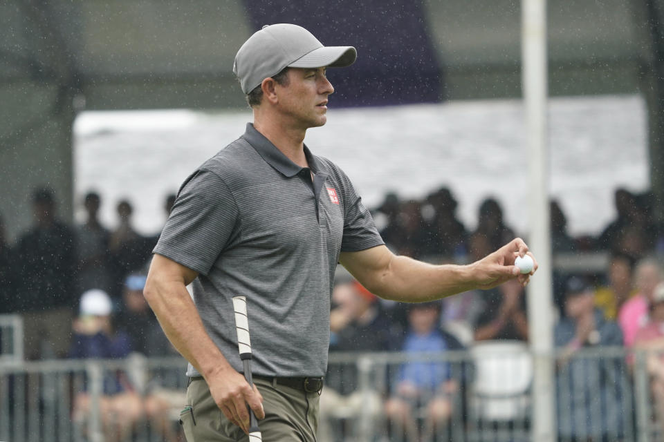 Adam Scott, of Australia, reacts after his putt on the ninth hole during the first round of the Wyndham Championship golf tournament in Greensboro, N.C., Thursday, Aug. 3, 2023. (AP Photo/Chuck Burton)