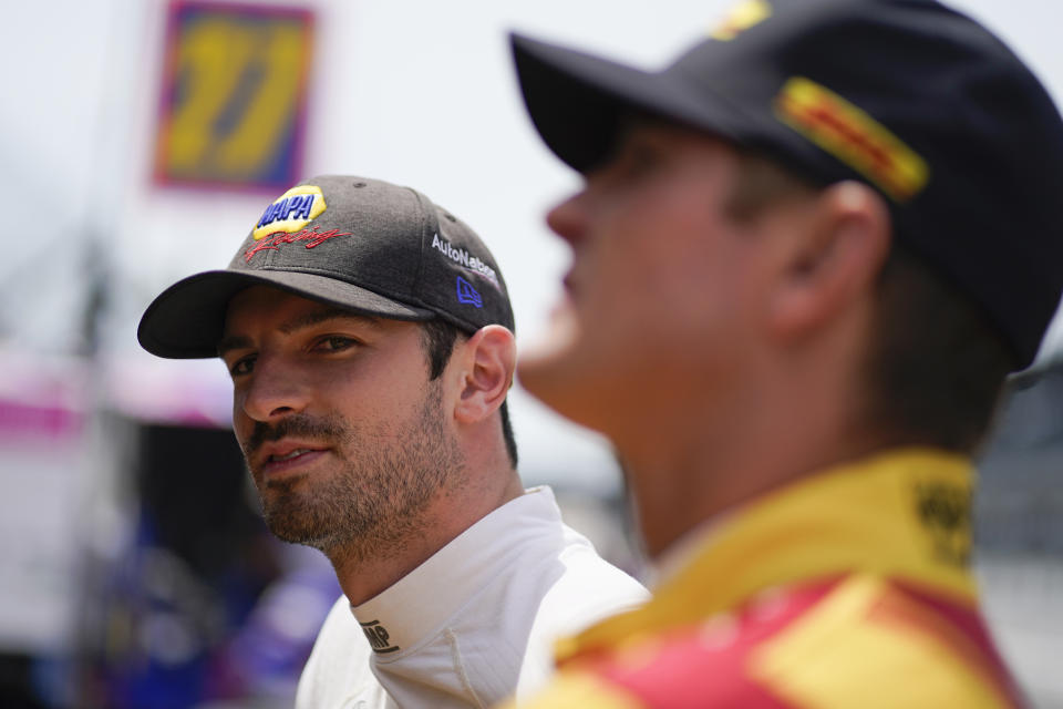 Alexander Rossi, left, looks down pit lane during practice for the Indianapolis 500 auto race at Indianapolis Motor Speedway, Friday, May 21, 2021, in Indianapolis. (AP Photo/Darron Cummings)