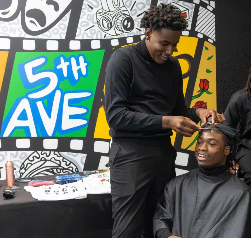 Jaylian Mack (left) tapes up model Shad Jordan (right) before the South Florida Fashion Academy’s Second Annual Student Fashion Show at the L.A. Lee YMCA/Mizell Community Center on Friday, June 7, 2024, in Fort Lauderdale, Florida.