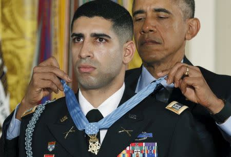 U.S. President Barack Obama presents retired Army Captain Florent Groberg, 32, with the Medal of Honor during a ceremony at the White House in Washington November 12, 2015. REUTERS/Kevin Lamarque