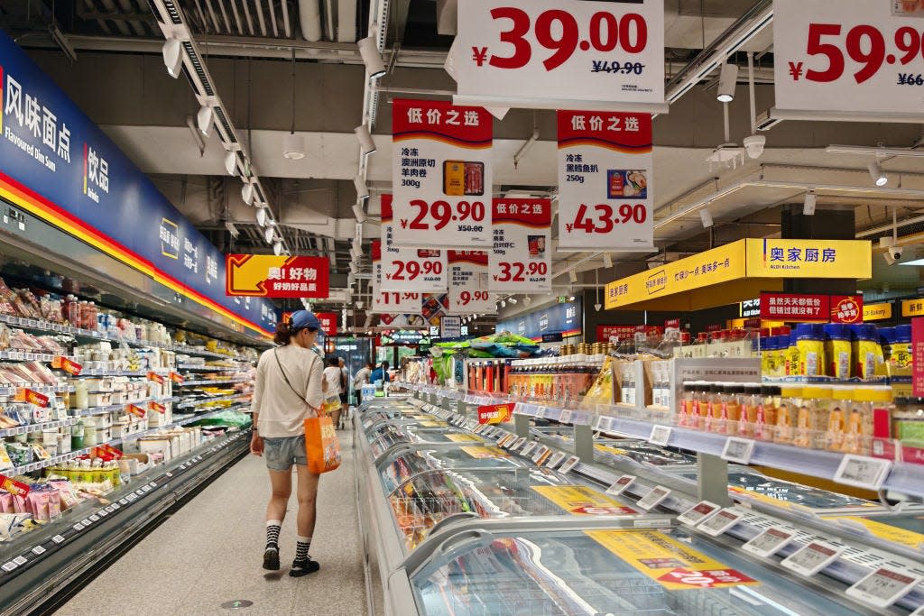 Residents select products at a supermarket in Shanghai, China.