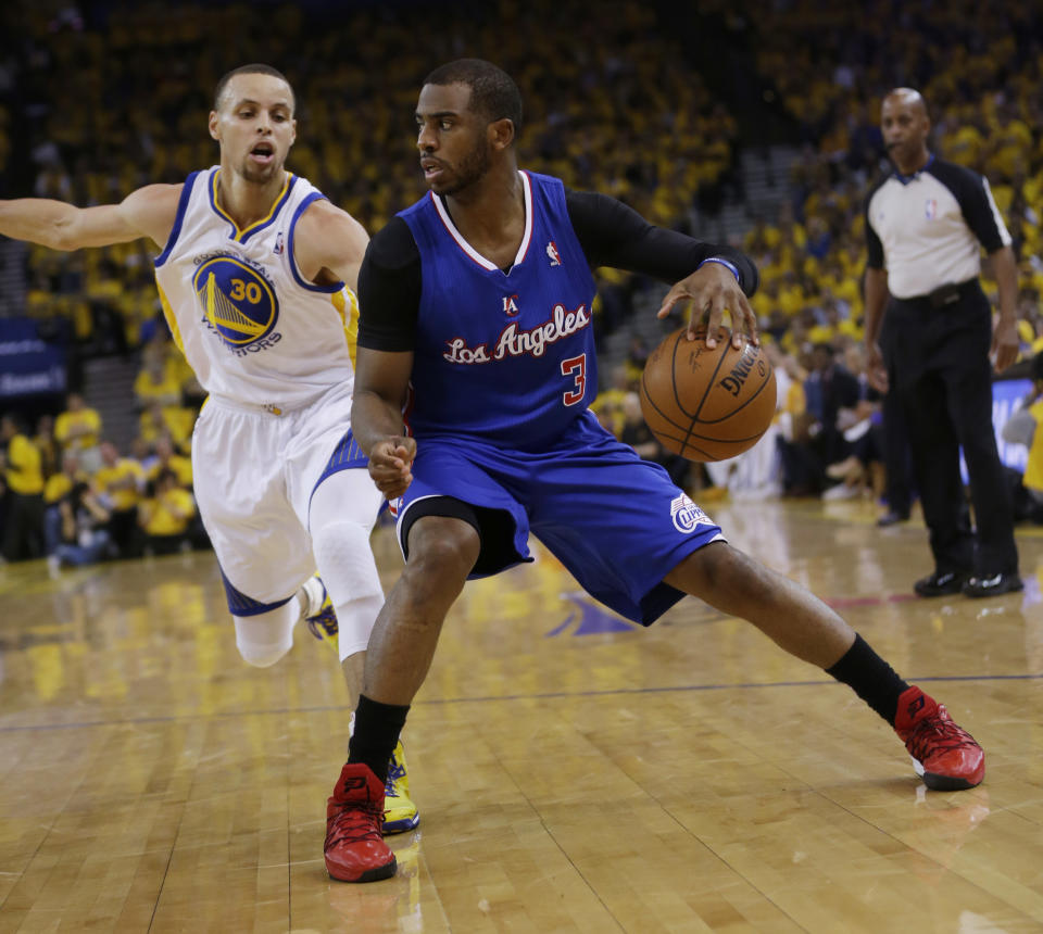 Los Angeles Clippers' Chris Paul (3) dribbles next to Golden State Warriors' Stephen Curry (30) during the first half in Game 4 of an opening-round NBA basketball playoff series on Sunday, April 27, 2014, in Oakland, Calif. (AP Photo/Marcio Jose Sanchez)