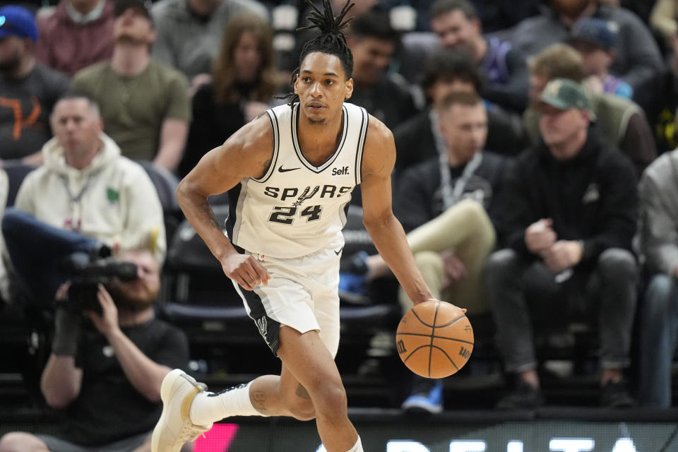 San Antonio Spurs guard Devin Vassell brings the ball up during the second half of the team's NBA basketball game against the Utah Jazz on Wednesday, March 27, 2024, in Salt Lake City. (AP Photo/Rick Bowmer)