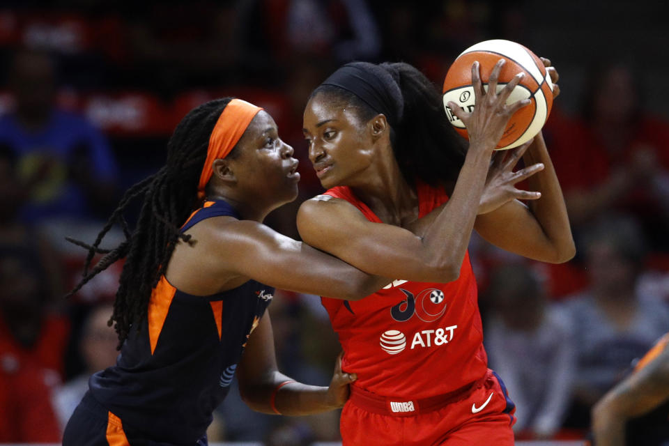 Washington Mystics forward LaToya Sanders, right, protects the ball from Connecticut Sun forward Jonquel Jones in the first half of Game 1 of basketball's WNBA Finals, Sunday, Sept. 29, 2019, in Washington. (AP Photo/Patrick Semansky)