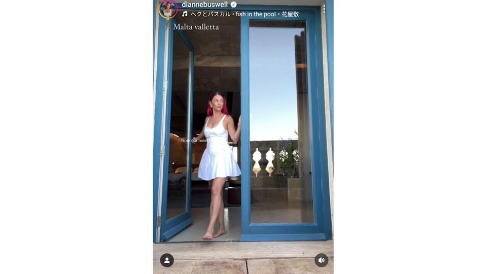 woman walking through door in white mini dress