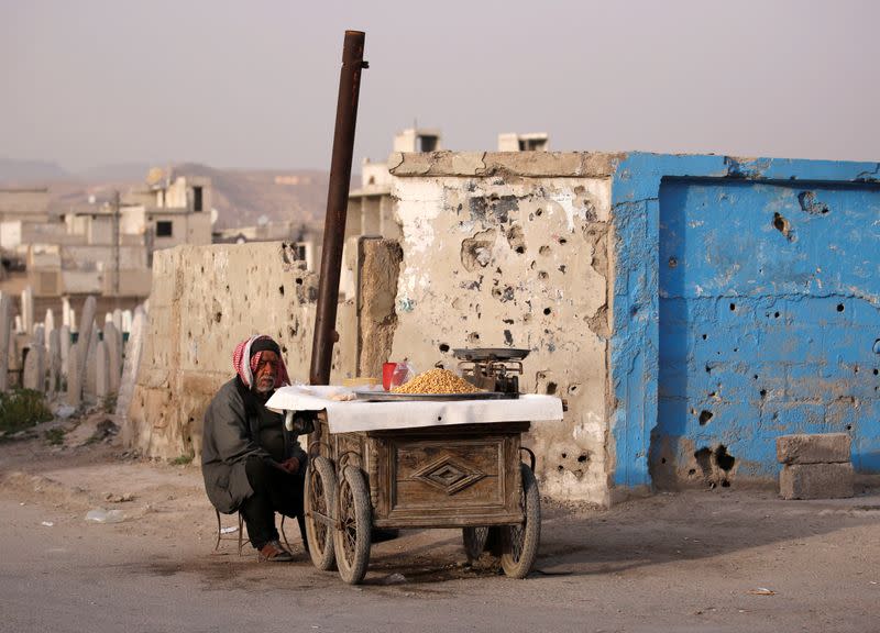 A street vendor waits for customers in Douma