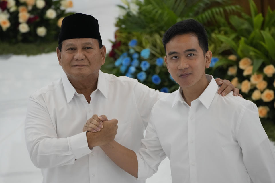 Indonesian Defense Minister and president-elect Prabowo Subianto, left, shakes hands with his running mate Gibran Rakabuming Raka, the eldest son of Indonesian President JokoWidodo, during their formal declaration as president and vice president-elect at the General Election Commission building in Jakarta, Indonesia, Wednesday, April 24, 2024. ndonesia’s electoral commission formally declared Subianto as the elected president in a ceremony on Wednesday after the country’s highest court rejected appeals lodged by two losing presidential candidates who are challenging his landslide victory. (AP Photo/Dita Alangkara)