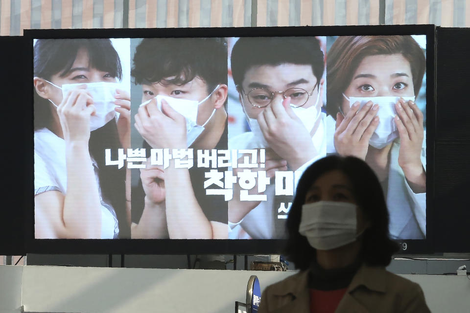 A screen shows precautions against the coronavirus at the Seoul Railway Station in Seoul, South Korea, Saturday, Nov. 7, 2020. The Korean letters read "Let's wear a mask in a good way" (AP Photo/Ahn Young-joon)