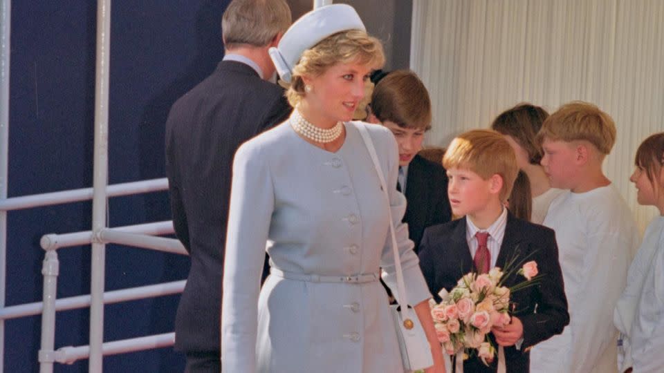 Princess Diana wearing a light blue suit and pillbox hat in 1995, accompanied by her son Prince Harry. - Princess Diana Archive/Hulton Archive/Getty Images