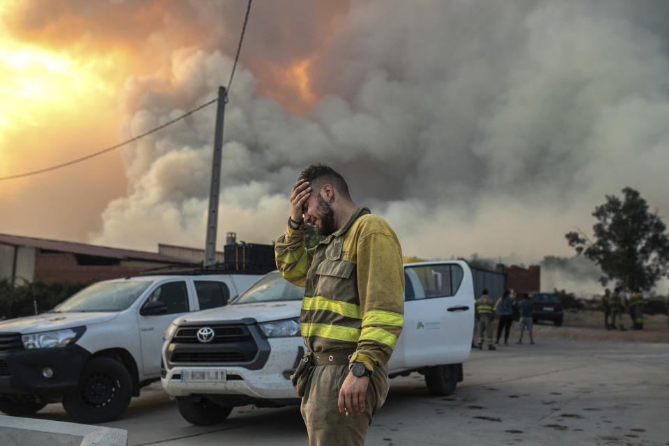 A firefighter cries near a wildfire in the Losacio area in north western Spain on Sunday July 17, 2022. Firefighters battled wildfires raging out of control in Spain and France as Europe wilted under an unusually extreme heat wave that authorities in Madrid blamed for hundreds of deaths. (Emilio Fraile/Europa Press via AP) **SPAIN OUT**