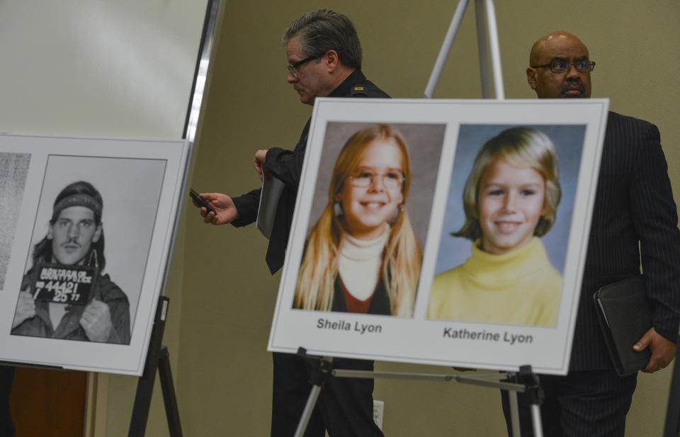 Montgomery County Police Captain behind a mug shot of Lloyd Lee Welch, Jr., the person of interest in the disappearance of the Lyon sisters,