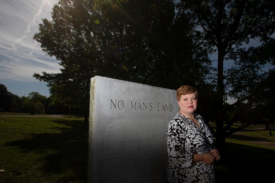 “You just want to give people a small bit of comfort, and it’s hard,” said Kim Bearden, executive director of historic Elmwood Cemetery, about new social distancing measures and funerals that restrict attendance to less than 10 people due to the coronavirus pandemic. Bearden stands next the memorial at Elmwood Cemetery for those who died of Yellow Fever in Memphis.