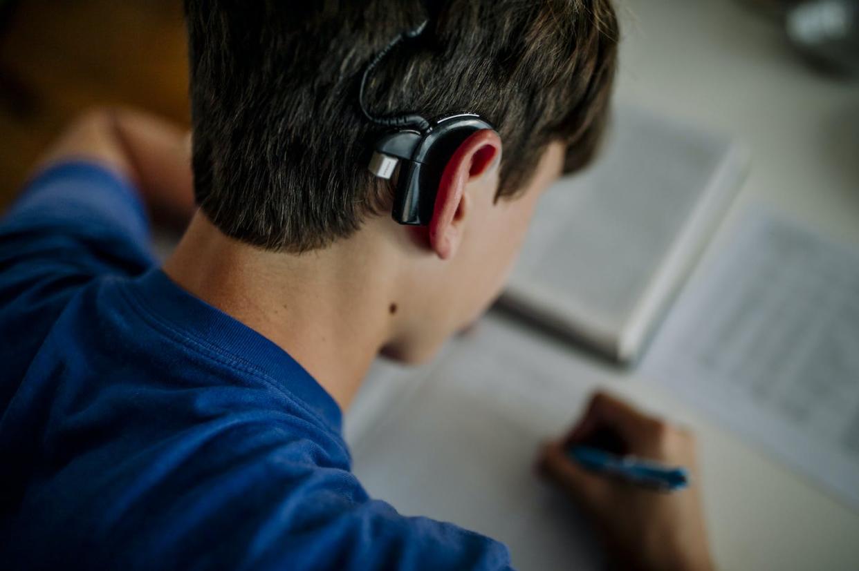 A patient's age upon receiving a cochlear implant can influence the technology's effectiveness. <a href="https://www.gettyimages.com/detail/photo/yr-old-boy-with-cochlear-implant-studying-and-royalty-free-image/1203208092" rel="nofollow noopener" target="_blank" data-ylk="slk:Cavan Images/Cavan via Getty Images;elm:context_link;itc:0;sec:content-canvas" class="link ">Cavan Images/Cavan via Getty Images</a>